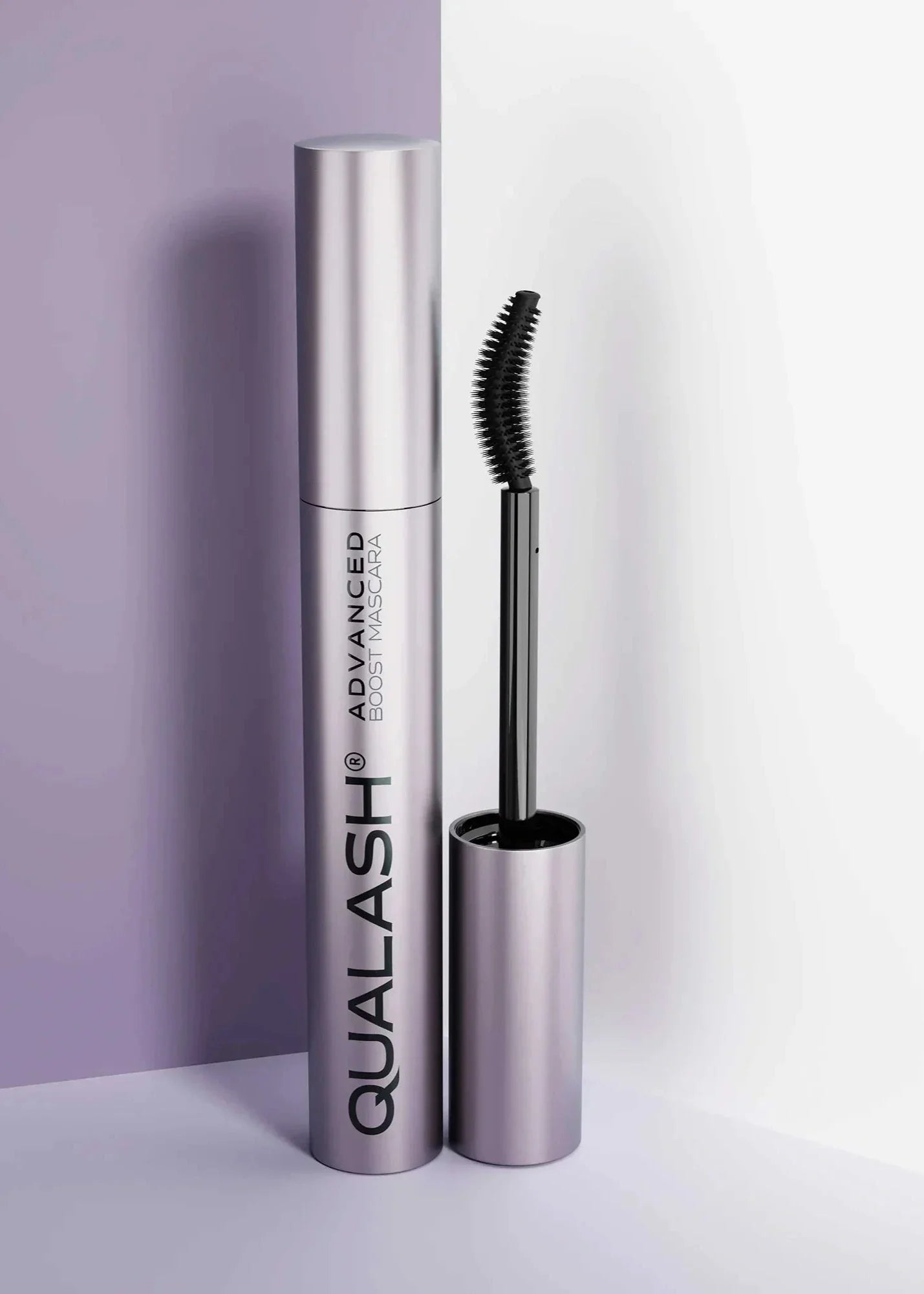 QUALASH Advanced Mascara Curl & Lift 10 ml with curved brush standing upright against a soft lilac and white background